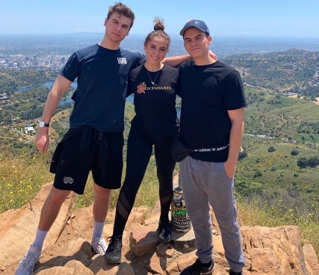 Brenna D'Amico as seen while posing with Preston Thompson (Right) and Christian Weissmann at Wisdom Tree Lake Hollywood in Los Angeles, California in May 2019