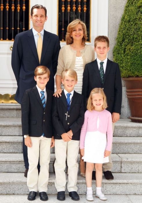 Juan seen standing next to his mother while posing with his family