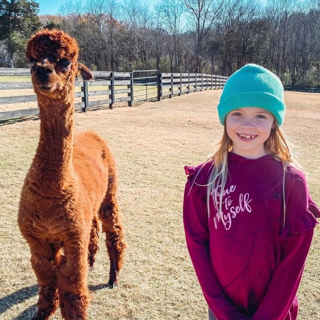 Maya Maxwell as seen in a picture that was taken in December 2020, while standing besides a lama
