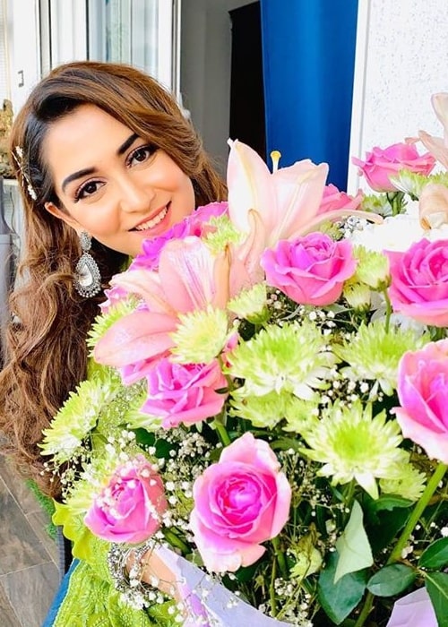 Srishti Jain as seen in a picture taken in January 2020, while holding a large bouquet of flowers